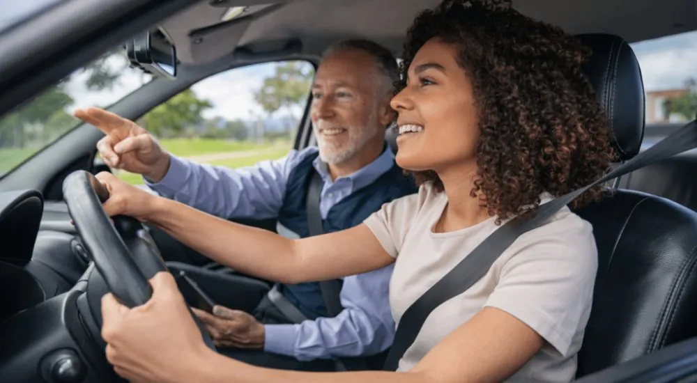 Learner driver receiving guidance from a driving instructor during a driving lesson.